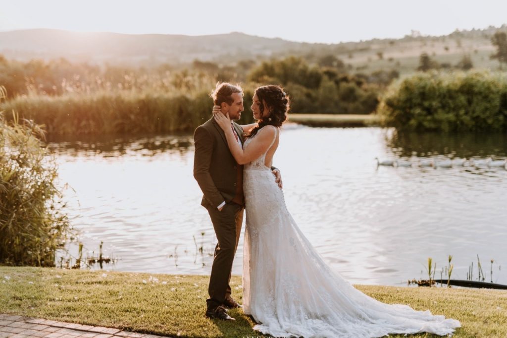 A wedding photographer capturing a couple's special moment in a scenic South African landscape.