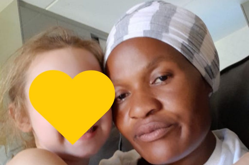 A woman and a child with heart-shaped accessories on their heads, sharing a happy moment together.