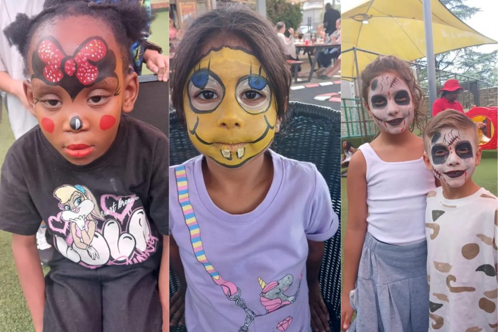 Children enjoying face painting at a vibrant park, with colorful designs and joyful expressions.