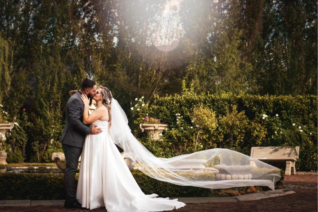 Romantic wedding scene, featuring the couple and the garden.